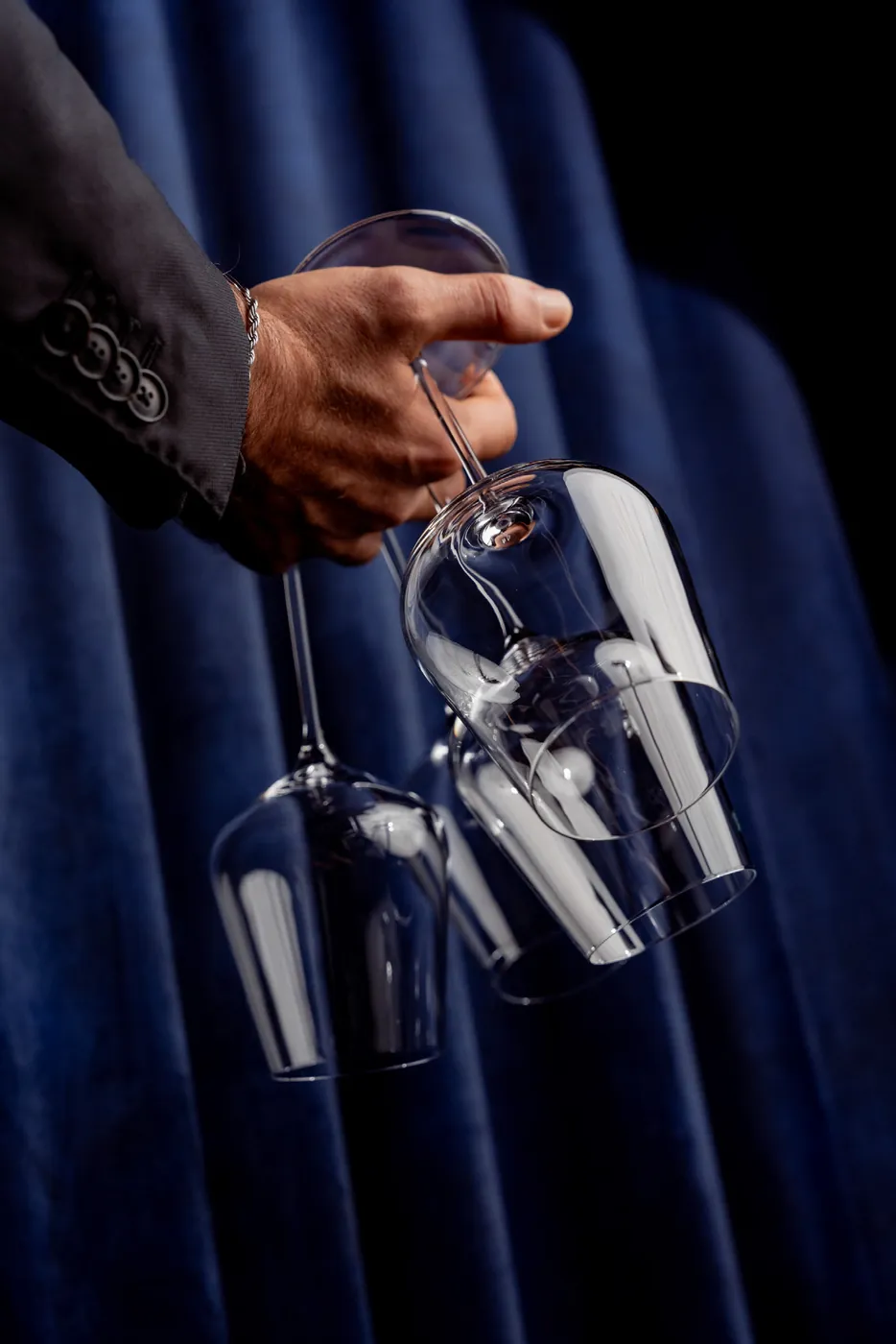 Wine glasses being lifted from the rack at Layla