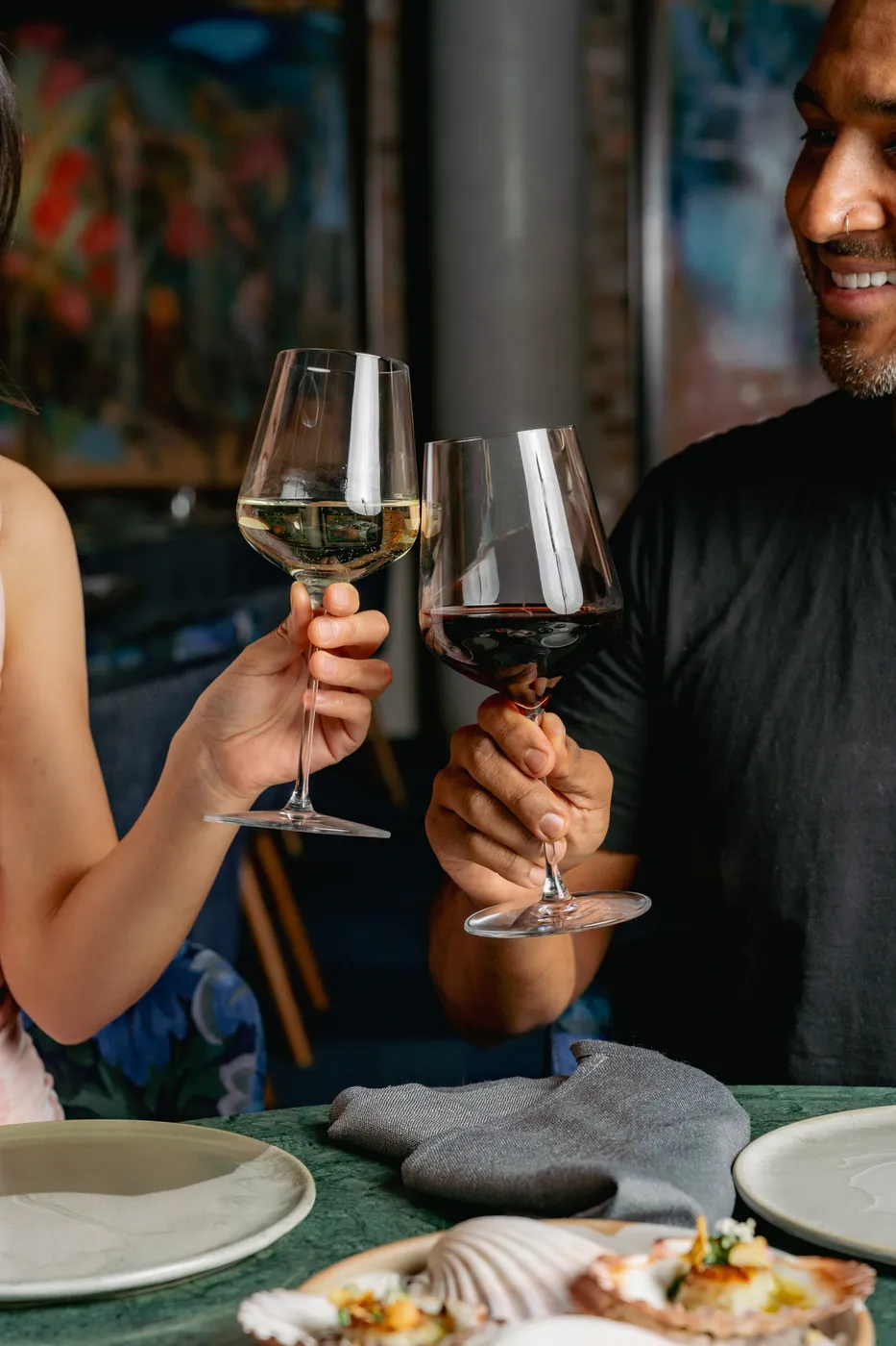 Two glasses of wine raised in a toast